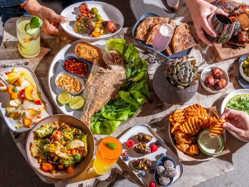 A shared spread of dishes and drinks